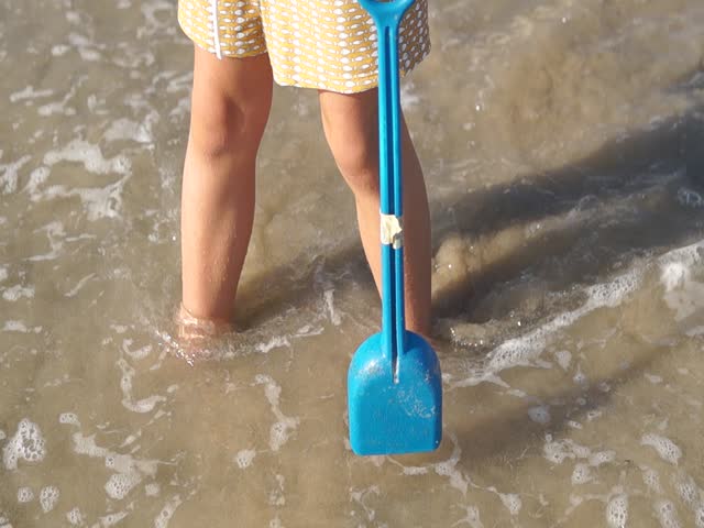 A child stands at the water