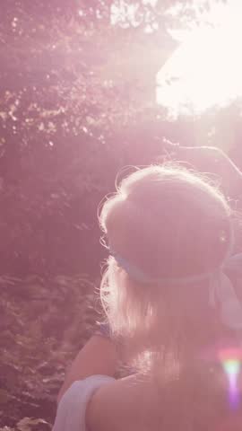 Mature belly dancer performing in a sunlit garden