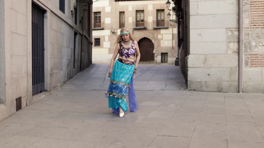 Mature belly dancer performing in a city street