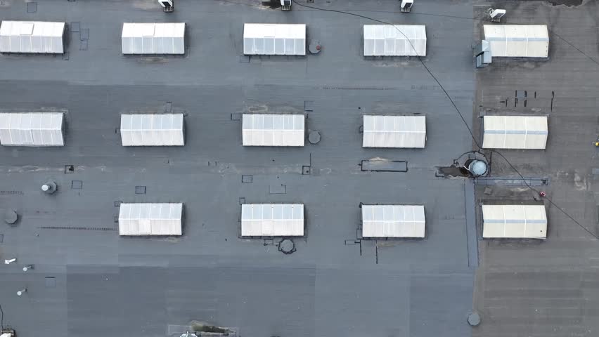 Roof with windows for natural light. Industrial buildings with flat roofs and windows for natural light. Energy savings. Green technologies.