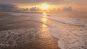 Golden sunset sun over Green Bowl Beach, Bali. Warm light reflecting on the Indian Ocean, foamy waves roll toward shore beneath a dramatic bright colorful sky. Natural background. Aerial drone flight - Powered by Shutterstock - Get 15% off with code: PIKWIZARD15