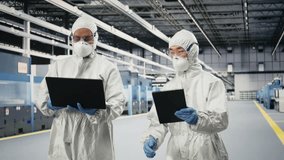 Monitoring microchip production, devices and engineering team brainstorming in factory cleanroom. Supervising semiconductors manufacturing, protective gear and teamworking colleagues, camera A - Powered by Shutterstock - Get 15% off with code: PIKWIZARD15