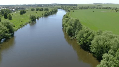 Drone Moving Forward above Calm River Green