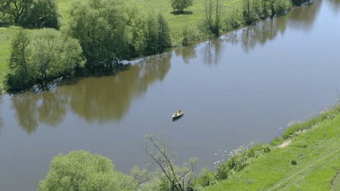 Drone Circling above Small Boat on Calm