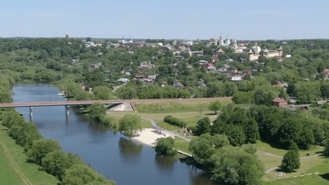 Aerial Circular Side Flight over River Town