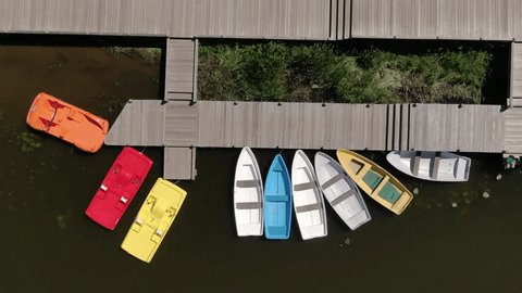 Drone Ascending Vertically above Dock Moored Boats