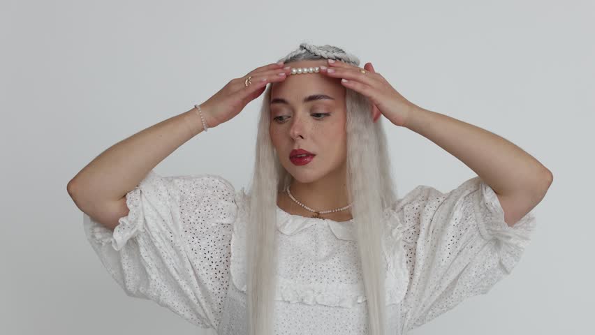 Beautiful girl dressed as elf on white background