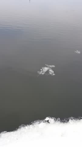 Floating Ice Along Coastal Edge of Newcastle Waterfront in Ontario Canada During Winter. Vertical Shot.