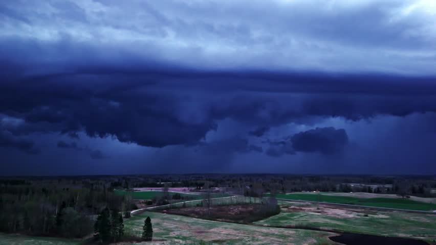 Dark storm clouds over rural land