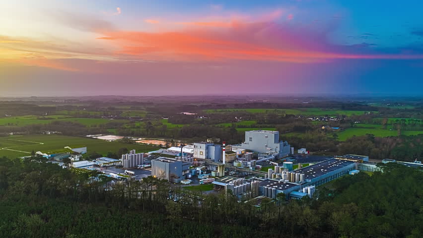 Industrial Plant - Manufacturing Facility Amidst Rural Nature At Sunset. Timelapse
