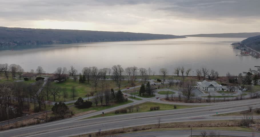 Ithaca, NY, USA - March 30, 2026  Late afternoon timelapse aerial video of the south end of Cayuga Lake and NYS Route 13 Ithaca, NY on an overcast spring day.