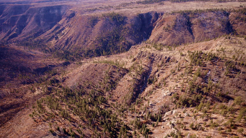 Sweeping aerial view of canyon system and arid scrub vegetation in northern New Mexico