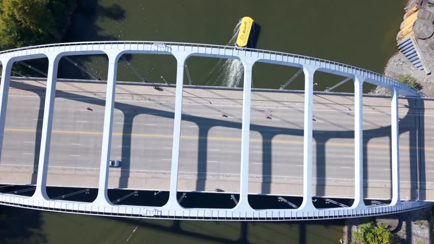 Cars Commuting Over A Bridge Spanning The Cumberland River In Downtown Nashville, Tennessee, aerial orbit ascending view