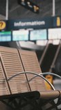 Mother and Small Kids Sit on Terminal Benches, Interacting With Smartphones, Passports. Reality Traveling With Toddlers, Passenger Waiting Experience, Lifestyle Modern Family Vacations. Vertical Shot. - Powered by Shutterstock - Get 15% off with code: PIKWIZARD15