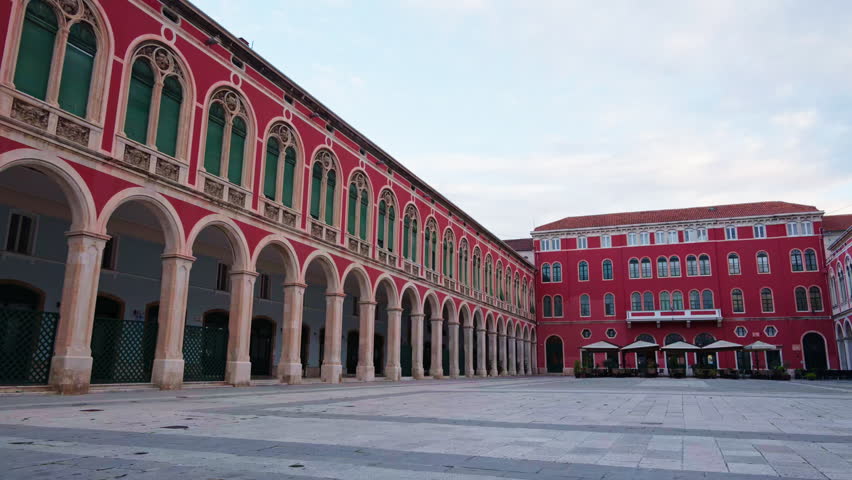 Neo Renaissance architecture dominating Republic Square in Split with characteristic red buildings and arcades. Croatia