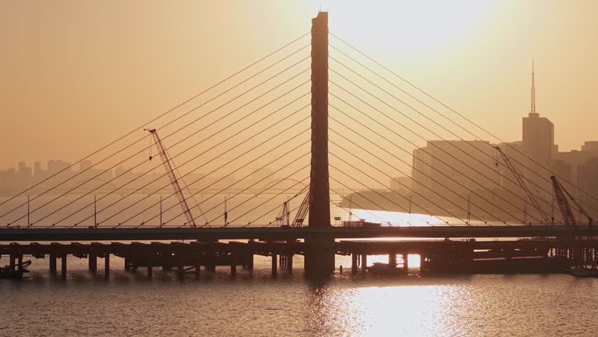 Aerial view of a river bridge construction at sunset in Hangzhou, China from