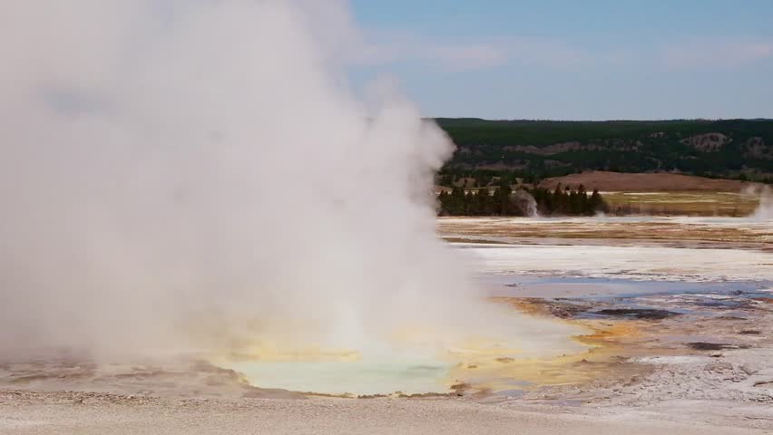 Dynamic Scene Of Yellowstone Geyser Erupting With Steaming Waters And Vivid Mineral Formations