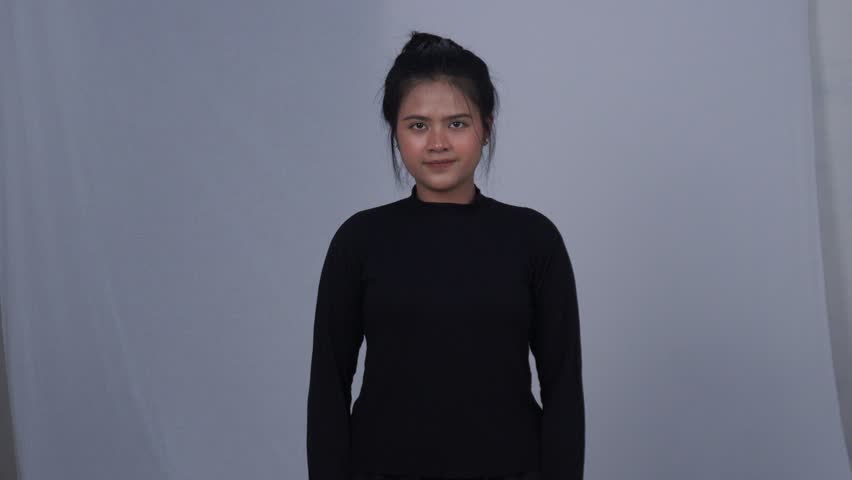 Asian woman in black doing indoor exercise