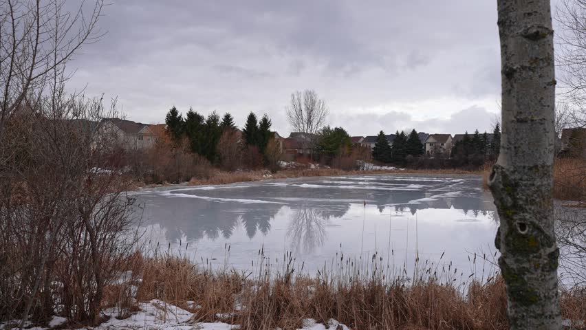 Ice Covered Lake in Urban Neighborhood at Kinross Park Oshawa Ontario Canada