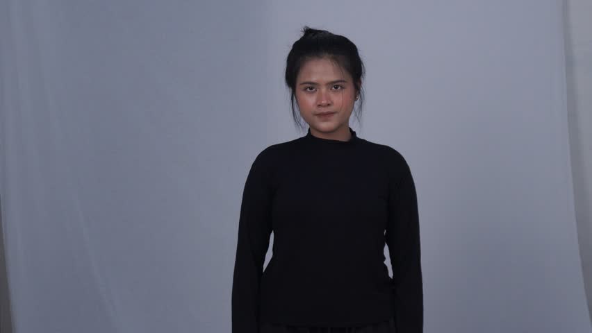 Asian woman in black doing indoor exercise