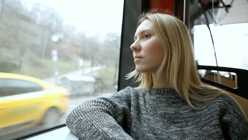 The young beautiful woman sitting in tram