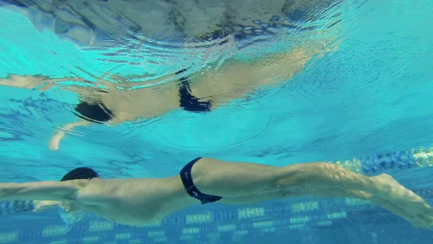 Beautiful underwater slow motion view of swimming butterfly style