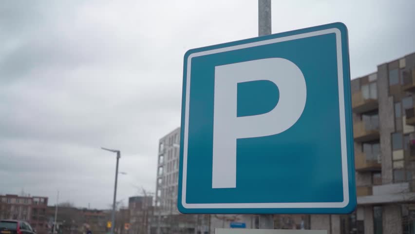Blue parking sign with letter P in urban environment, close up traffic symbol in city