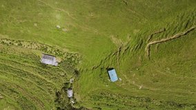 Aerial drone footage of solar panels installed in green mountain areas for providing electricity and lighting. Highlights renewable energy, rural development, and eco-friendly solutions. - Powered by Shutterstock - Get 15% off with code: PIKWIZARD15