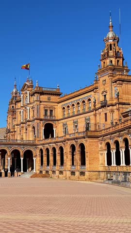 Wide angle shot of the historic Plaza de España in Seville under blue sky - 4k vertical travel footage