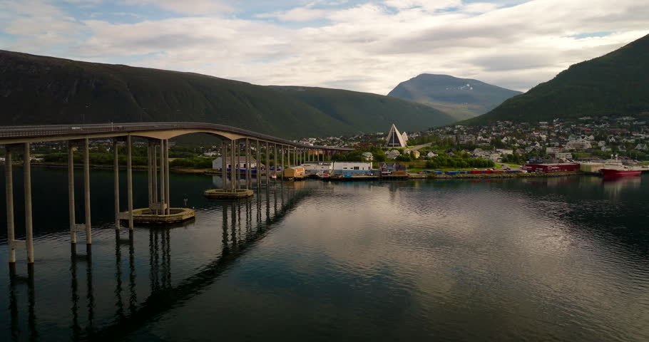 Tromso Bridge and Arctic Cathedral, drone birds eye view. Tromso cityscape, coastal Norway.