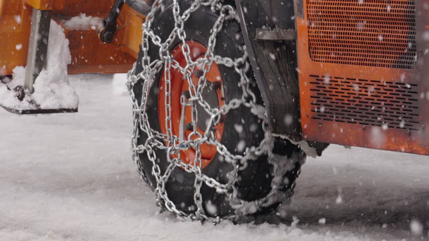 Heavy duty truck wheels with snow chains driving