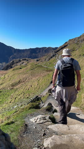 Walker on the Pyg Track Path from Pen y Pass ascending Snowdon Mountain, Snowdonia National Park, North Wales, UK