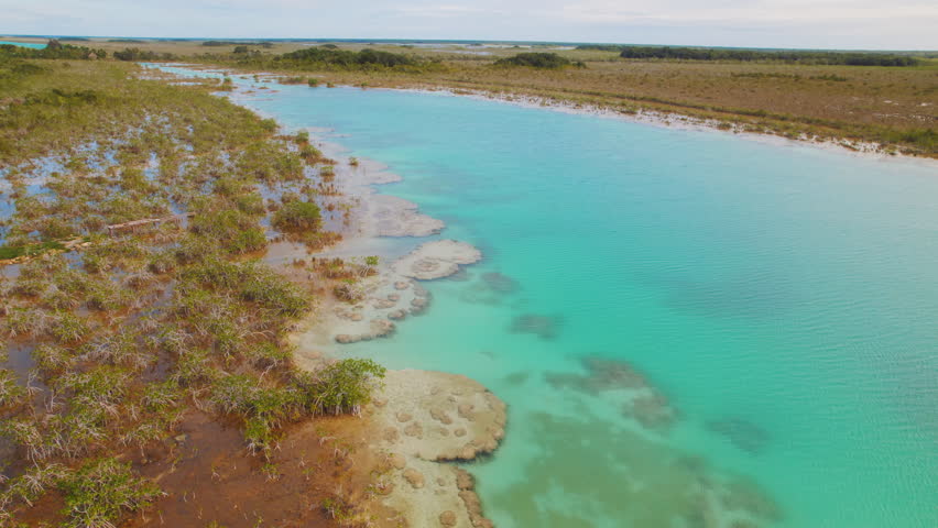 Aerial view of turquoise water Bacalar Lagoon with stromatolites in Mexico