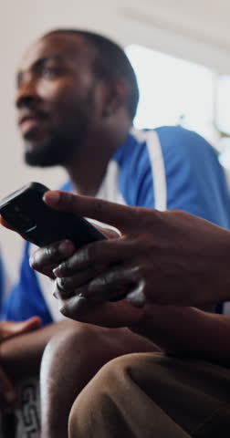 Hands, phone and watching tv with friends, soccer game and texting with streaming service. Men, group and smartphone with scroll, typing and notification on mobile app with football fans at home