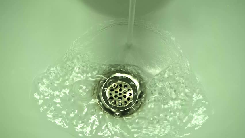 Painter removing paint from brushes with water