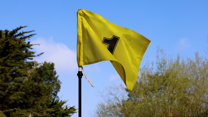 Yellow Number One Flag Waving on a Golfcourse Close Up