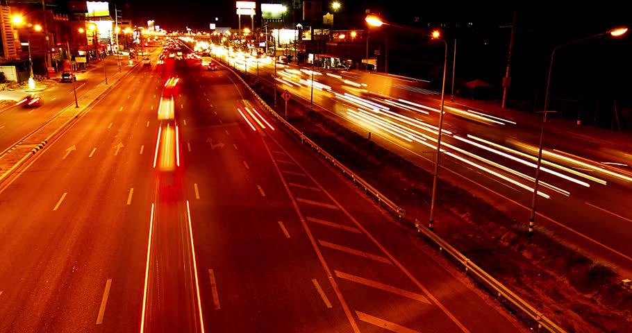 Time lapse of freeway busy city road during rush hour fast moving freeway traffic at night showing cars with light streaks 4k HD