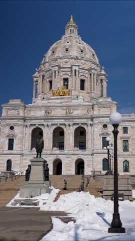 State Capitol building in St Paul Minnesota shows snow covering the ground and details of the architecture without any people present