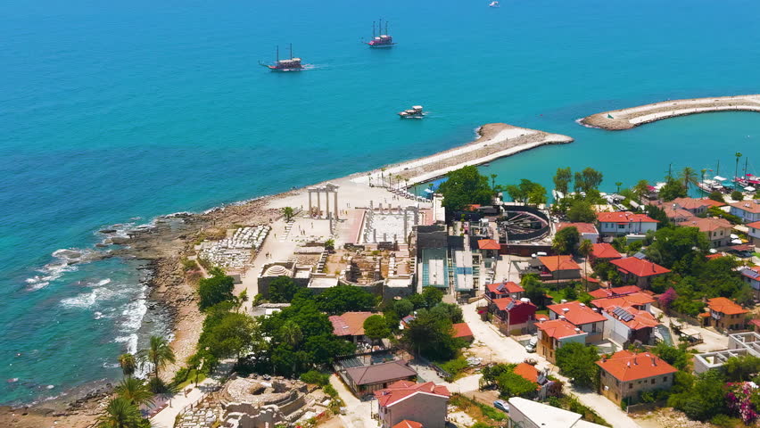 Dolly zoom. Side, Manavgat, Turkey. Temple of Apollo and Athena near harbor, South Basilica. On shore, ancient ruins and Mediterranean coast aerial view on sunny day. Aerial View. Rich colors