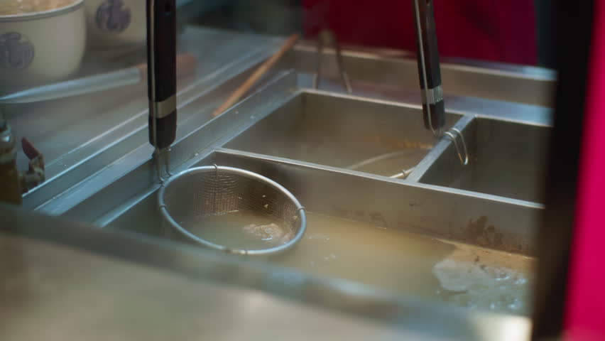 Chef cooking ramen noodles in strainer over hot broth, delicious Asian street food and culinary culture