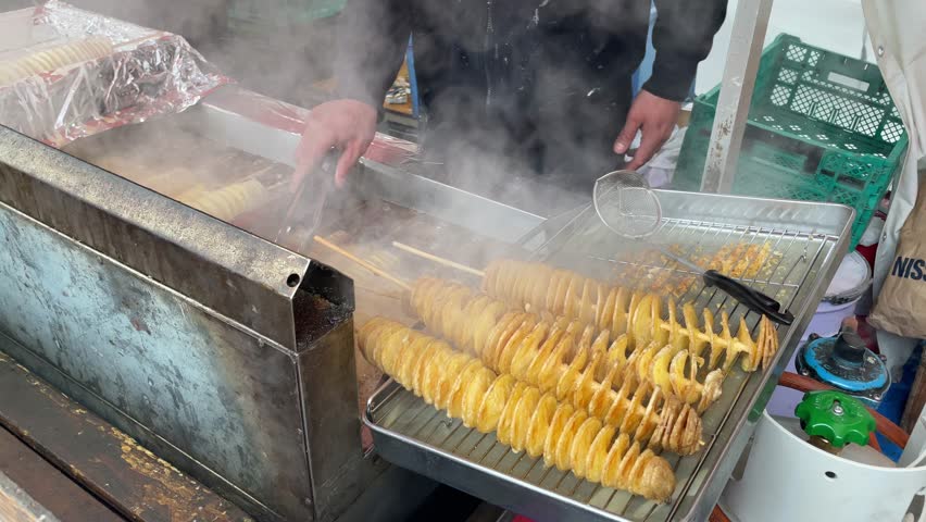Crispy Golden Tornado Potato Skewers Frying in Hot Oil Street Food Stall