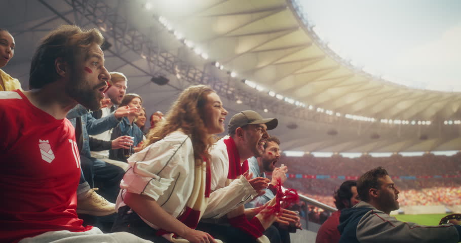 Diverse Fans in Big Stadium Cheer and Celebrate During a Soccer Championship Event, Backing Their Team in a Professional Arena as a Dramatic Goal Sparks Joy at an World League Cup Match