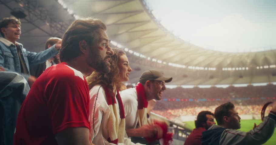 Diverse Fans in a Packed Stadium Cheer and Celebrate a Soccer Goal During a Championship Sport Event, Backing Their Team in a Professional Arena at a Major International League Match.