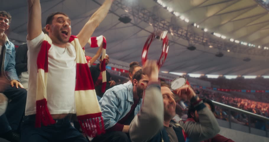 Diverse Fans in a Packed Stadium Cheer and Celebrate a Soccer Goal During a Championship Sport Event, Backing Their Team in a Professional Arena at a Major International League Match.