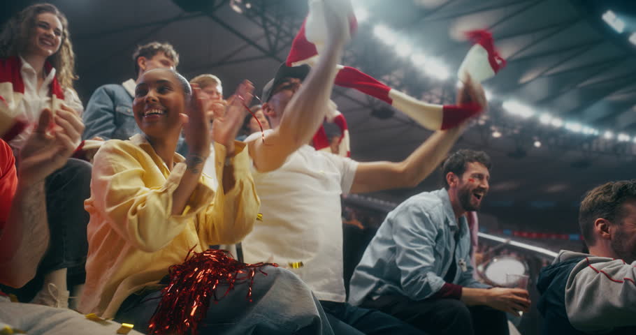 Portrait of Happy Multicultural Soccer Fans Cheering and Applauding in a Packed Stadium During a Professional International League Championship Match, With Confetti and Scarves, Slow Motion.