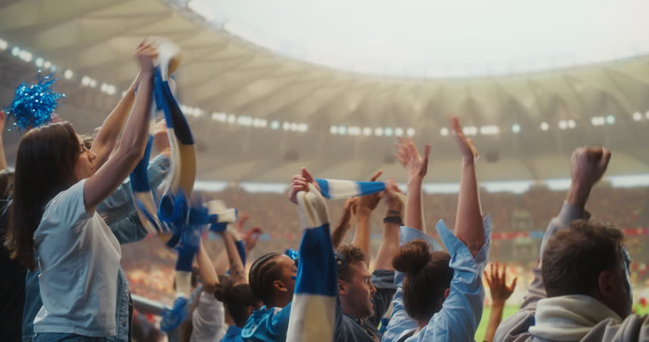 Happy Multiracial Soccer Fans in a Packed Stadium Raise Arms and Cheer at Kickoff of a Professional International League Match, Celebrating the Start of a World Event With Hope for Victory.