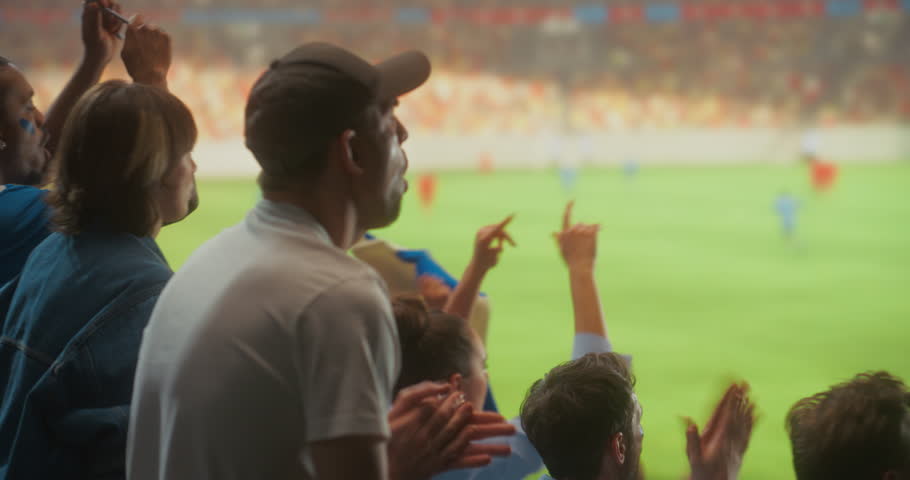 Diverse Happy Soccer Fans Celebrate Together in a Packed stadium Cheering for Their Team During a Professional League Match and Major International Tournament, With a Lively Crowd and Field View.