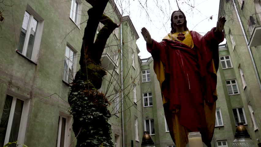 Shrine with statue of Jesus on inner court of tenement house in Praga-Polnoc district of Warsaw, Poland, 4k video