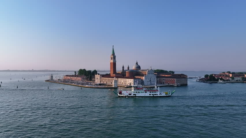 Island skyline with ferry approaching across calm water, morning light bathing basilica and campanile, ferry captain guiding