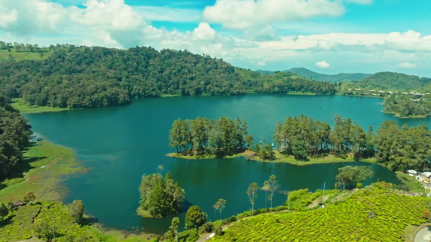Blue Lake Surrounded by Green Hills Landscape